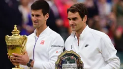 Novak Djokovic poses with the 2015 Wimbledon trophy next to Roger Federer.