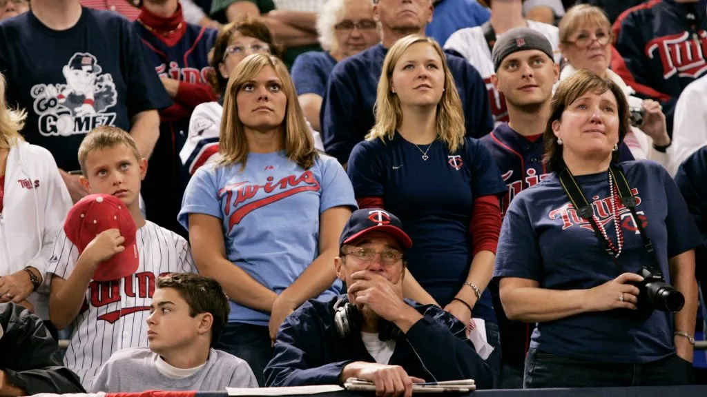 Minnesota Twins fans watch as a video tribute to former player Kirby Puckett is shown during a ceremony marking the end of Twins’ baseball inside the Hubert H. Humphrey Metrodome on October 4, 2009. (Source: Genevieve Ross/Getty Images)