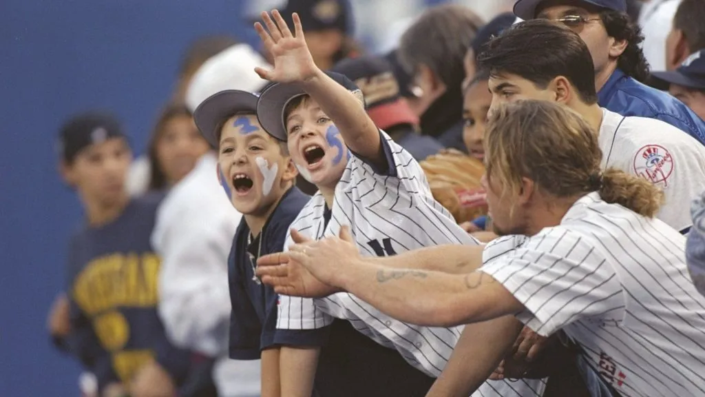 Fans of the New York Yankees wave during game six of the World Series against the Atlanta Braves at Yankee Stadium in 1996. (Source: Doug Pensinger/Allsport)