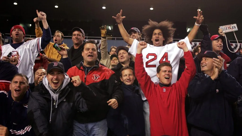 The Boston Red Sox fans celebrate after defeating the New York Yankees 10-3 to win game seven of the American League Championship Series on October 20, 2004. (Source: Al Bello/Getty Images)
