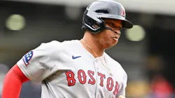 Rafael Devers #11 of the Boston Red Sox rounds the bases after a solo home run during the third inning of game one of a doubleheader against the Cleveland Guardians.