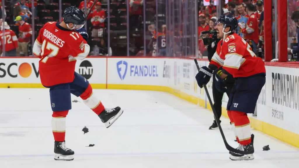 Evan Rodrigues #17 sends a plastic rat at Brad Marchand #63 in a postgame ritual following a win over t he Carolina Hurricanes of Game Three of the Eastern Conference Final of the 2025 Stanley Cup Playoffs at Amerant Bank Arena on May 24, 2025 in Sunrise, Florida.