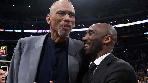 Kobe Bryant and Kareem Abdul-Jabbar shshare a moment at halftime after both of Bryant's #8 and #24 Los Angeles Lakers jerseys are retired at Staples Center on December 18, 2017 in Los Angeles, California.