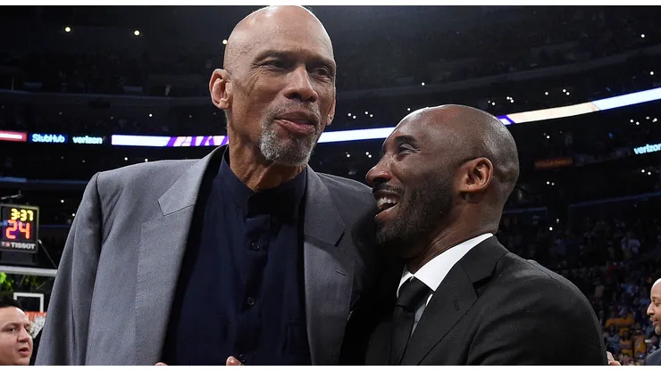 Kobe Bryant and Kareem Abdul-Jabbar shshare a moment at halftime after both of Bryant's #8 and #24 Los Angeles Lakers jerseys are retired at Staples Center on December 18, 2017 in Los Angeles, California.