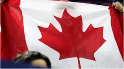 A spectator holds a Canadian flag