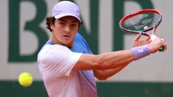 Joao Fonseca plays a backhand during the 2025 Roland Garros