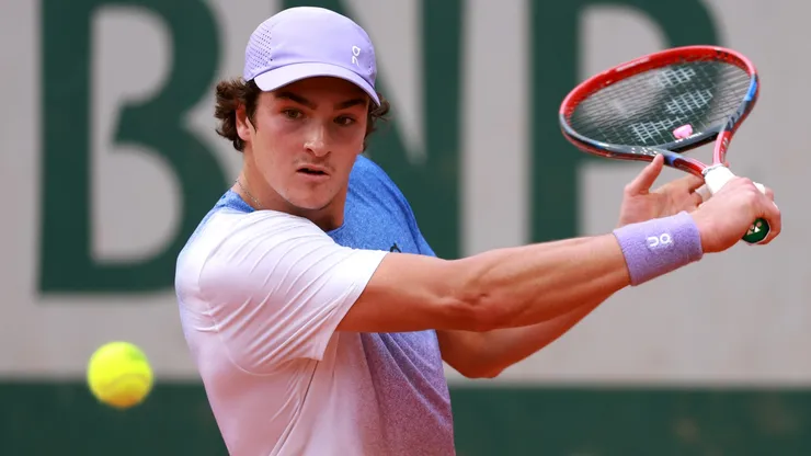 Joao Fonseca plays a backhand during the 2025 Roland Garros
