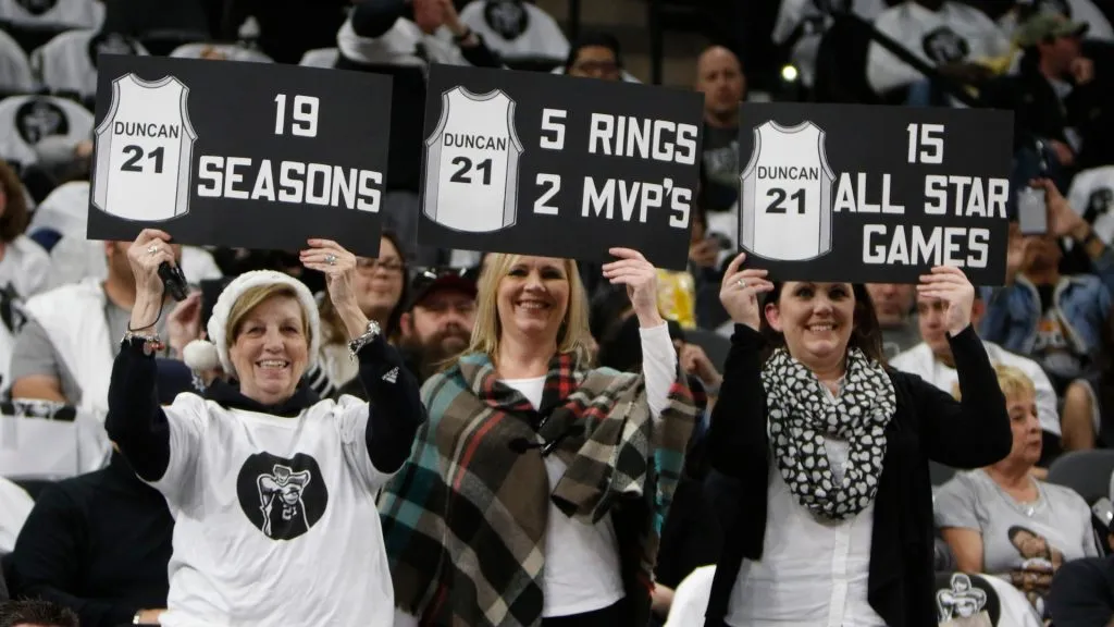 San Antonio Spurs fans hold signs honoring Tim Duncan before the start of their game against the New Orleans Pelicans at AT&T Center on December 18, 2016. (Source: Ronald Cortes/Getty Images)