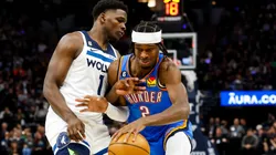Shai Gilgeous-Alexander #2 of the Oklahoma City Thunder drives to the basket while Anthony Edwards #1 of the Minnesota Timberwolves defends
