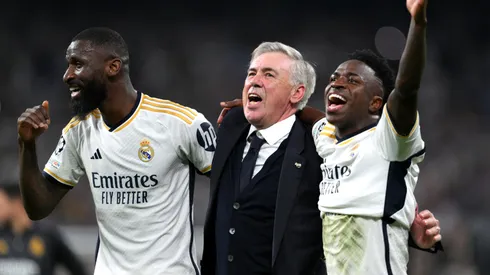 Antonio Ruediger, Carlo Ancelotti and Vinicius Junior of Real Madrid celebrate after the team's victory during the UEFA Champions League semi-final second leg match in 2024.