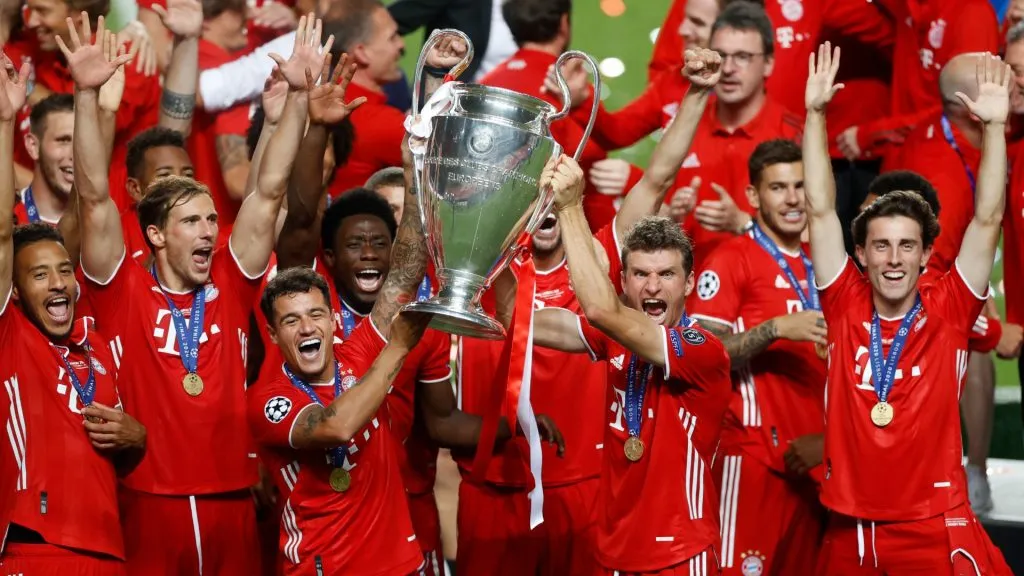 Philippe Coutinho and Thomas Mueller of FC Bayern Munich lift the UEFA Champions League Trophy following their team’s victory in the UEFA Champions League Final in 2020. (Source: Matt Childs/Pool via Getty Images)