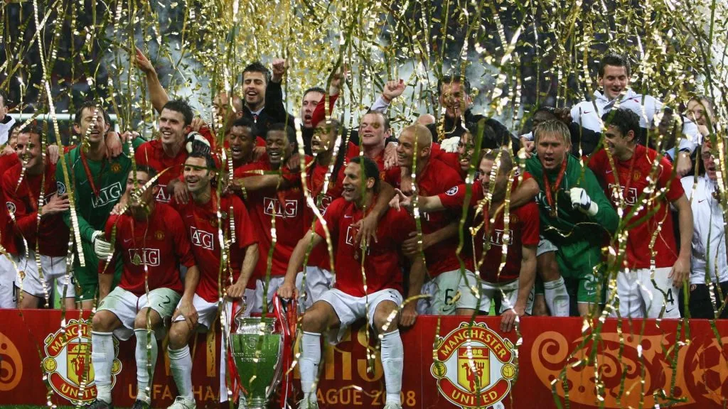 Manchester United players celebrate with the trophy following their team’s victory during the UEFA Champions League Final match in 2008. (Source: Alex Livesey/Getty Images)