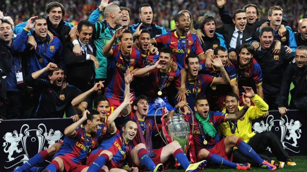 Lionel Messi and Daniel Alves of Barcelona hold the trophy as the team pose for photographs after victory in the UEFA Champions League final in 2011. (Source: Jasper Juinen/Getty Images)