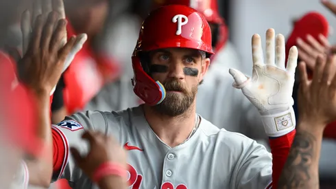 Bryce Harper #3 of the Philadelphia Phillies celebrates with teammates after hitting a two-run home run during the eighth inning against the Cleveland Guardians.