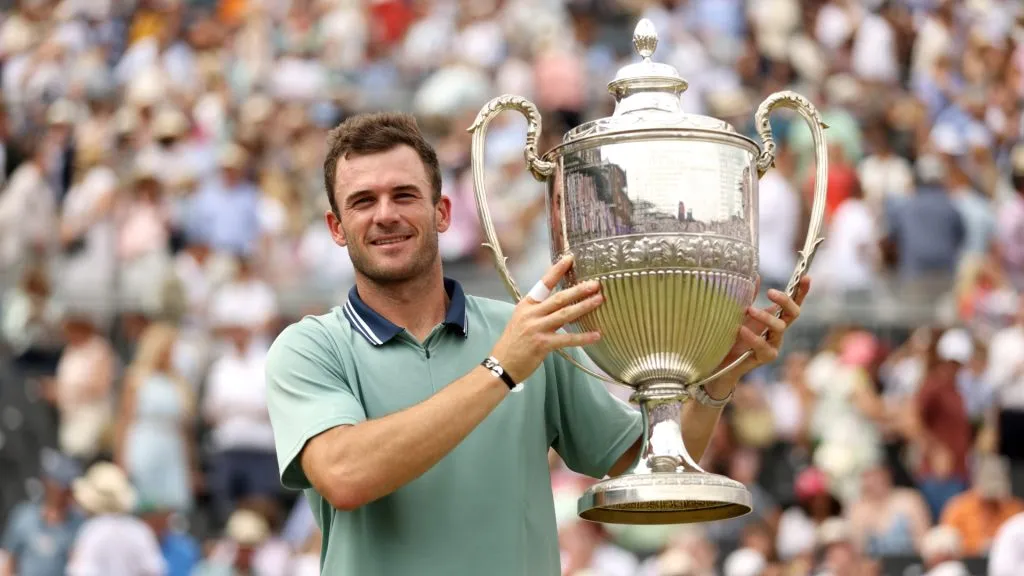 Tommy Paul poses for a photo with the cinch Championships 2024 winners trophy following victory against Lorenzo Musetti in the Men’s Singles Final match on Day Seven. (Source: Luke Walker/Getty Images for LTA)