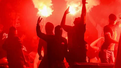 Fans of Paris Saint-Germain light red flares in celebration following the team's victory and subsequent progression into the final after the UEFA Champions League 2024/25 Semi Final Second Leg match between Paris Saint-Germain and Arsenal FC
