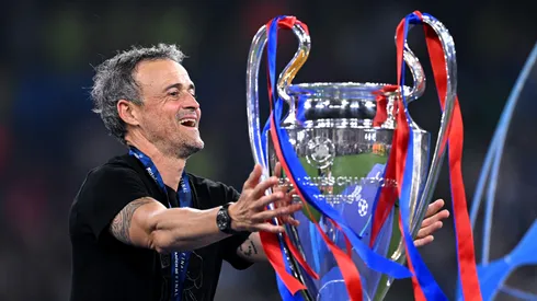 Luis Enrique, Head Coach of Paris Saint-Germain, reacts as he walks past the UEFA Champions League trophy after collecting his winners medal after defeating FC Internazionale.