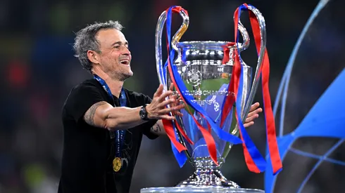 Luis Enrique, Head Coach of Paris Saint-Germain, reacts as he walks past the UEFA Champions League trophy
