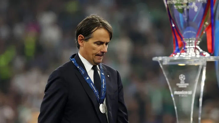 Simone Inzaghi, Head Coach of FC Internazionale, looks dejected as he walks past the UEFA Champions League trophy