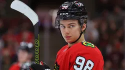 Connor Bedard #98 of the Chicago Blackhawks looks on against the Minnesota Wild during the first period of a preseason game at the United Center on October 05, 2023 in Chicago, Illinois.