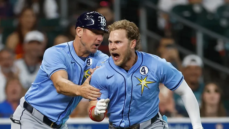 Taylor Walls #6 of the Tampa Bay Rays is held back by a coach after returning from the dugout after being ejected in the ninth inning against the Houston Astros at Daikin Park on June 01, 2025 in Houston, Texas.
