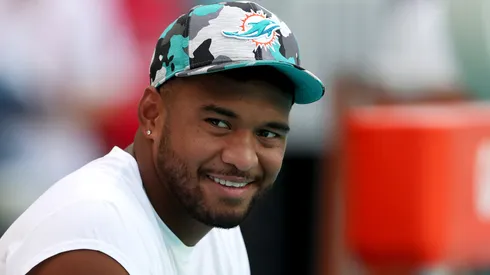Tua Tagovailoa #1 of the Miami Dolphins looks on from the bench prior to a game against the Philadelphia Eagles at Hard Rock Stadium on August 27, 2022 in Miami Gardens, Florida.