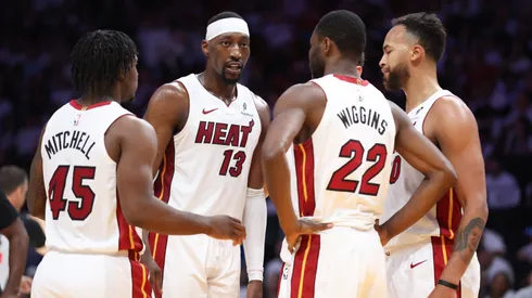 Bam Adebayo #13 of the Miami Heat huddles with teammates.