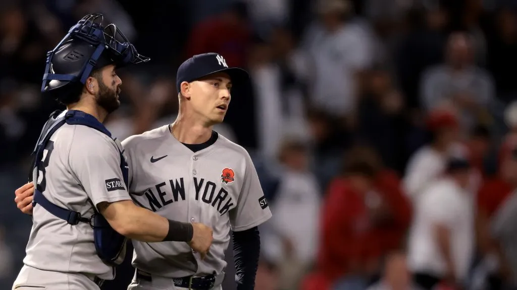 Austin Wells #28 and Luke Weaver #30 of the New York Yankees celebrate after the 5-1 win against the Los Angeles Angels
