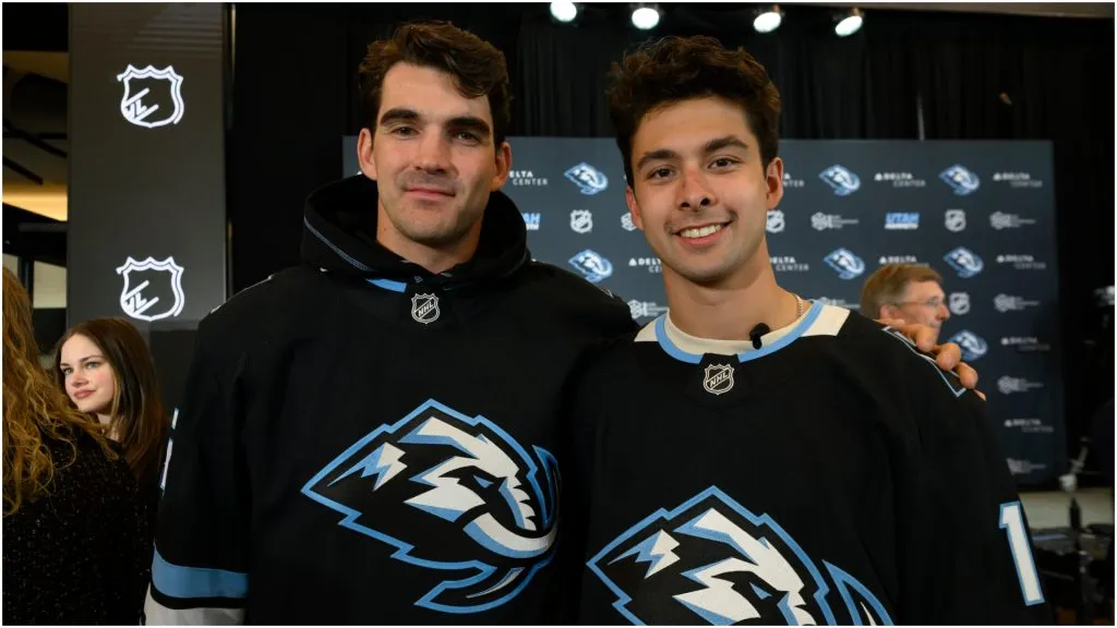 Utah Mammoth players Jack McBain, left, and Dylan Guenther, right, are shown in the home black jerseys with the new logo during an introductory press conference announcing the Utah Mammoth as the permanent franchise name at Delta Center on May 7, 2025 in Salt Lake City, Utah.