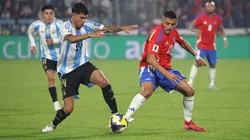 Alexis Sanchez of Chile controls the ball whilst under pressure from Exequiel Palacios of Argentina