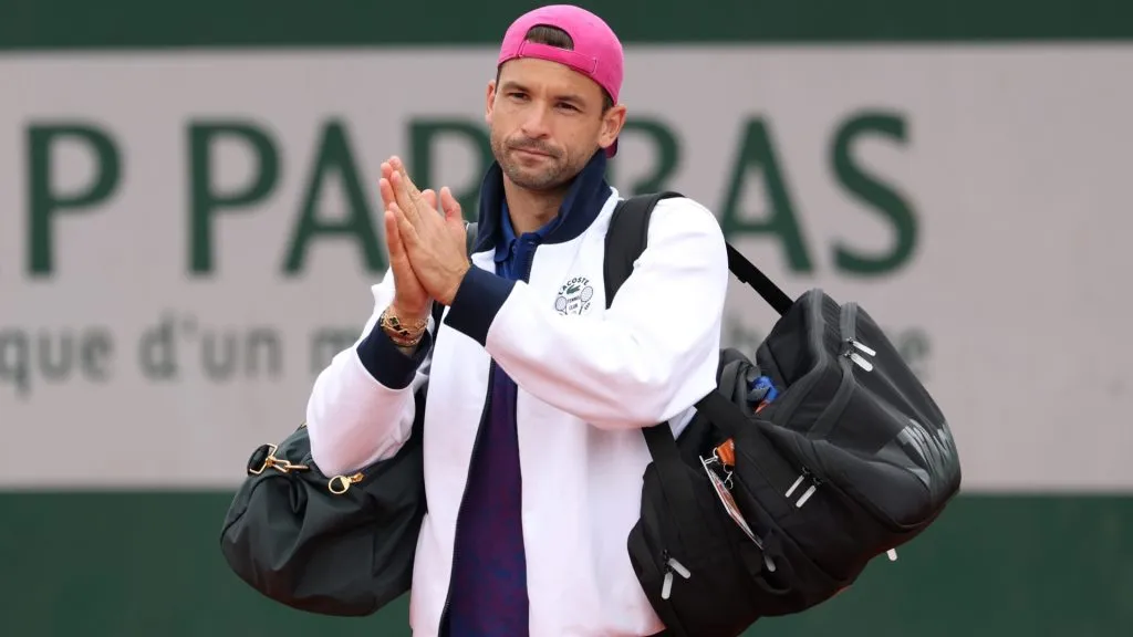 Grigor Dimitrov applauds spectators after retiring injured from his Men’s Singles First Round match against Ethan Quinn of United States during Day Three of the 2025 French Open. (Source: Julian Finney/Getty Images)
