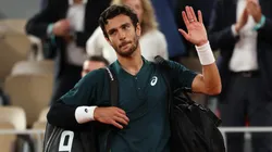 Lorenzo Musetti of Italy waves to the crowd as he leaves court after retiring injured from the Roland Garros semifinal vs Carlos Alcaraz.