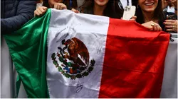 Fans hold a Mexico flag