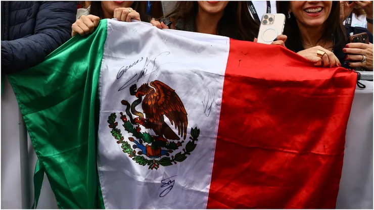 Fans hold a Mexico flag