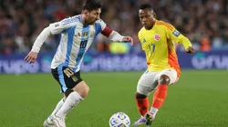 Lionel Messi of Argentina runs with the ball whilst under pressure from Jáminton Campaz of Colombia during a FIFA World Cup 2026 South American Qualifier game.