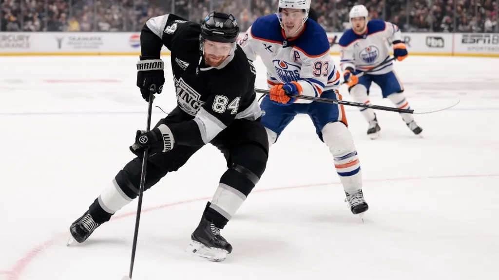 Vladislav Gavrikov #84 of the Los Angeles Kings skates with the puck against Ryan Nugent-Hopkins #93 of the Edmonton Oilers during the second period in Game Two of the First Round of the 2025 Stanley Cup Playoffs at Crypto.com Arena on April 23, 2025 in Los Angeles, California. (Photo by Harry How/Getty Images)