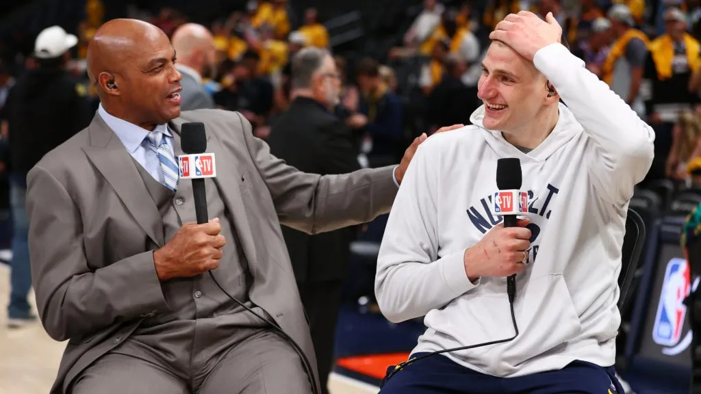 Charles Barkley speaks with Nikola Jokic during the 2023 NBA Finals, while working for TNT. (Jamie Schwaberow/Getty Images)