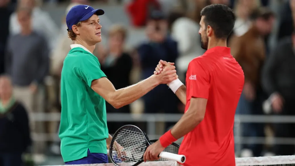 Jannik Sinner of Italy shakes hands with Novak Djokovic of Serbia at the net after his victory at Roland Garros. (Clive Brunskill/Getty Images)