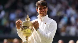Carlos Alcaraz of Spain celebrates with the trophy after defeating Novak Djokovic of Serbia at Wimbledon.