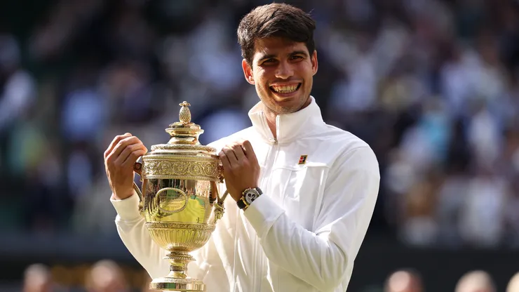 Carlos Alcaraz of Spain celebrates with the trophy after defeating Novak Djokovic of Serbia at Wimbledon.
