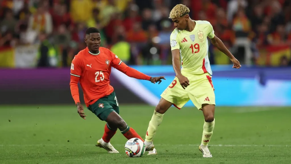 Lamine Yamal of Spain is challenged by Nuno Mendes of Portugal during the UEFA Nations League 2025 final. (Lars Baron/Getty Images)