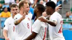 Jonathan David #20 celebrates with teammates after scoring a goal against Cuba during Canada's 7-0 win.