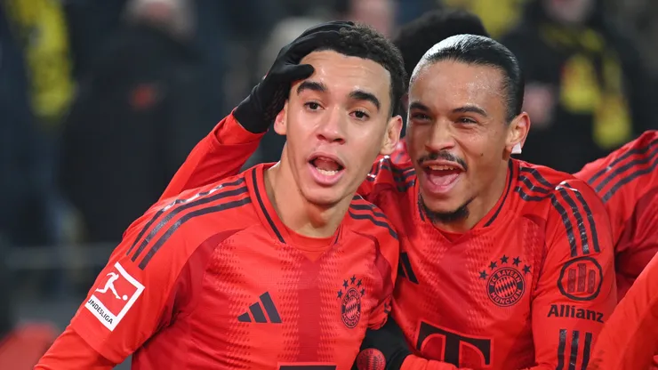 Jamal Musiala of Bayern celebrates scoring his goal with Leroy Sané during the Bundesliga match between Borussia Dortmund and FC Bayern München at Signal Iduna Park on November 30, 2024 in Dortmund, Germany.