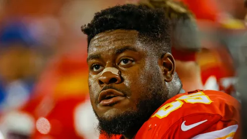 Trey Smith #65 of the Kansas City Chiefs sits on the Chiefs bench during the game against the Denver Broncos at Arrowhead Stadium on December 5, 2021 in Kansas City, Missouri.