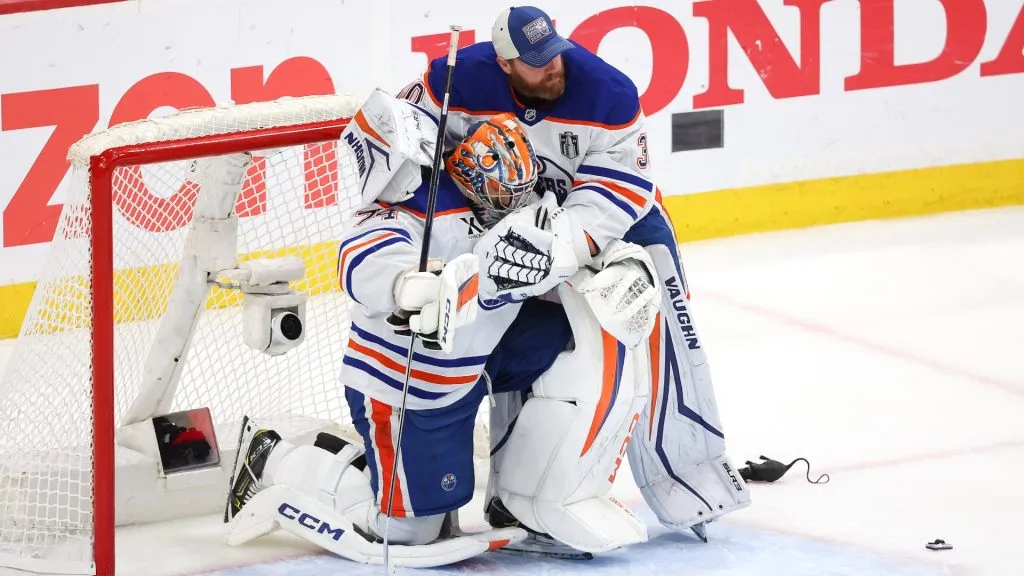 Stuart Skinner #74 of the Edmonton Oilers is hugged by Calvin Pickard #30 following their team’s defeat against the Florida Panthers in Game Six of the 2025 Stanley Cup Final at Amerant Bank Arena on June 17, 2025 in Sunrise, Florida. (Photo by Mike Carlson/Getty Images)