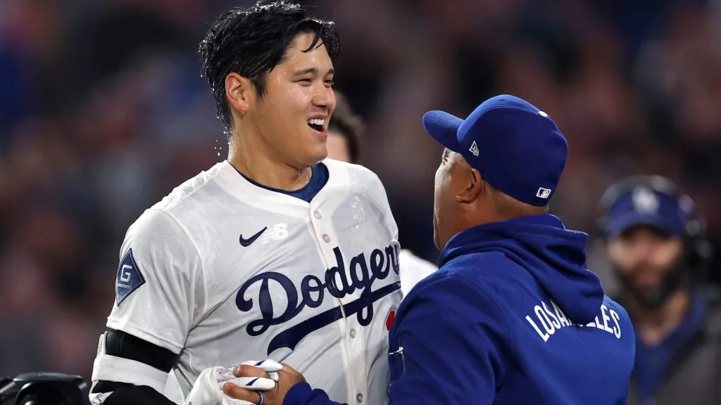 Shohei Ohtani and Dodgers manager Dave Roberts share a moment as the team continues shaping the two-way star’s pitching return plan. (Photo by Ronald Martinez/Getty Images)
