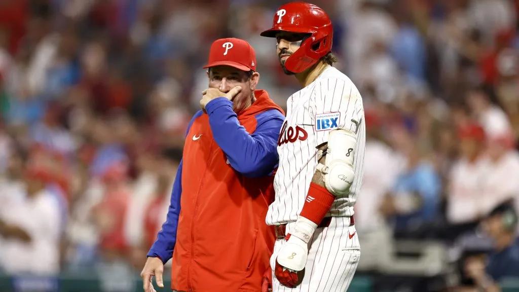 Rob Thomson #59 and Nick Castellanos #8 of the Philadelphia Phillies speak during the fifth inning against the Tampa Bay Rays at Citizens Bank Park on September 10, 2024 in Philadelphia, Pennsylvania. (Photo by Tim Nwachukwu/Getty Images)