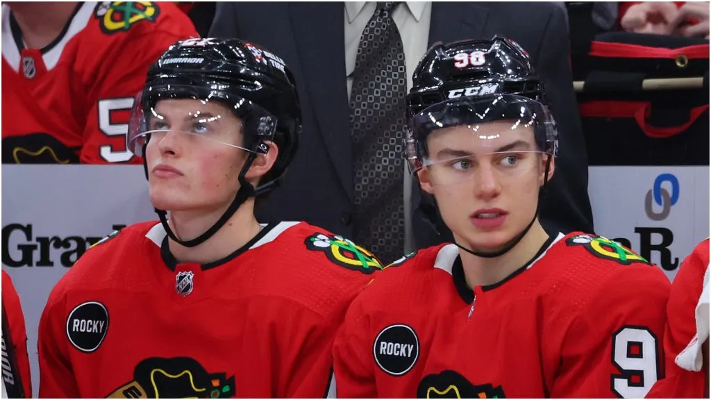 Lukas Reichel #27 and Connor Bedard #98 of the Chicago Blackhawks look on against the Minnesota Wild during the third period of a preseason game at the United Center on October 05, 2023 in Chicago, Illinois
