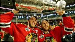 Jonathan Toews #19 and Patrick Kane #88 of the Chicago Blackhawks celebrate by hoisting the Stanley Cup after defeating the Tampa Bay Lightning in Game Six of the 2015 NHL Stanley Cup Final at the United Center on June 15, 2015 in Chicago, Illinois.