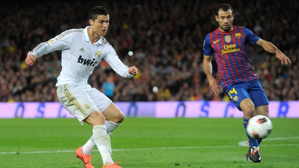 Cristiano Ronaldo (L) of Real Madrid CF scores his team’s 2nd goal while Javier Masherano of FC Barcelona looks on during the La Liga match. (Denis Doyle/Getty Images)